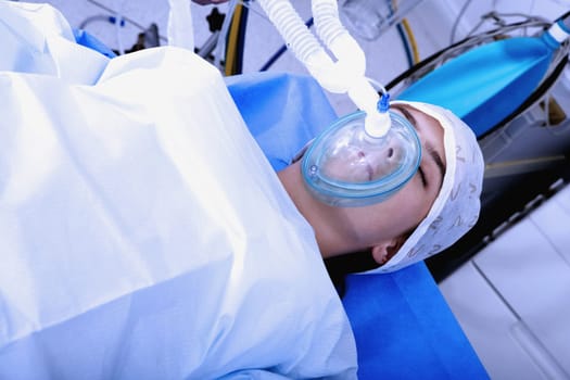 High angle view of a female patient lying on an operating table