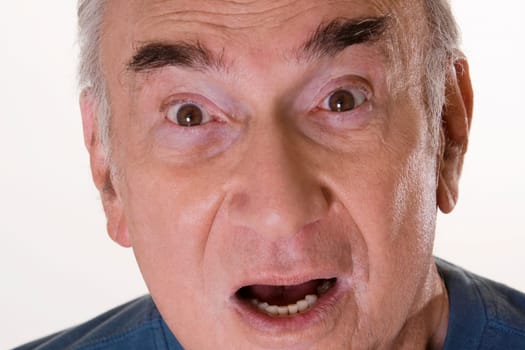 Portrait of a senior man looking shocked