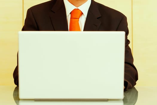 Mid section view of a businessman using a laptop