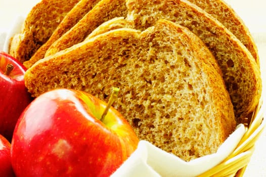 Close-up of apples and brown bread in a basket