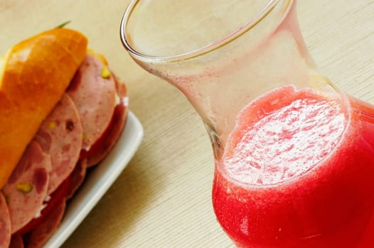 Close-up of a sandwich with a glass of juice