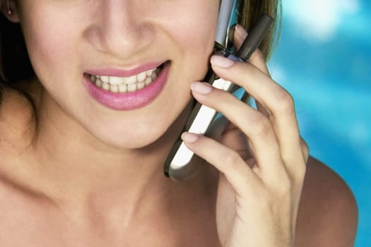 Close-up of a young woman using a mobile phone and smiling