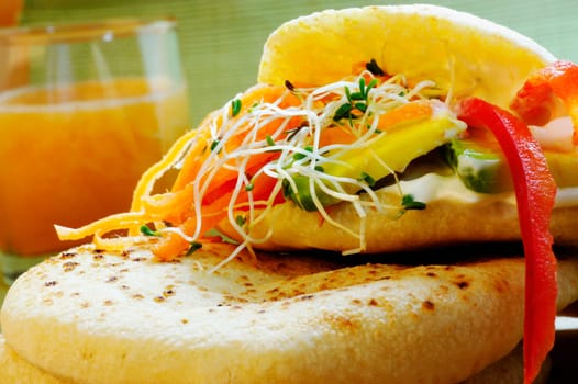 Close-up of a sandwich with a glass of juice