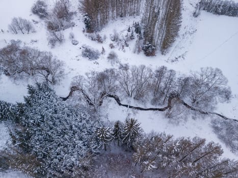 Aerial view of partially deforested landscape with creek, winter theme. Czech Republic, Vysocina region highland