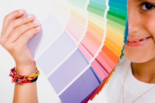 Portrait of a girl holding color swatches