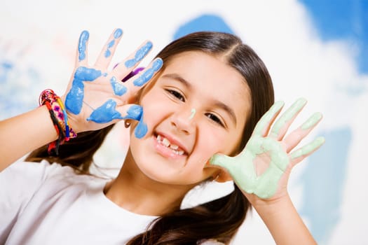 Portrait of a girl showing paint on her palms