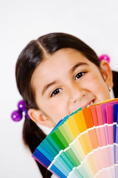 Portrait of a girl with color swatches in front of her face