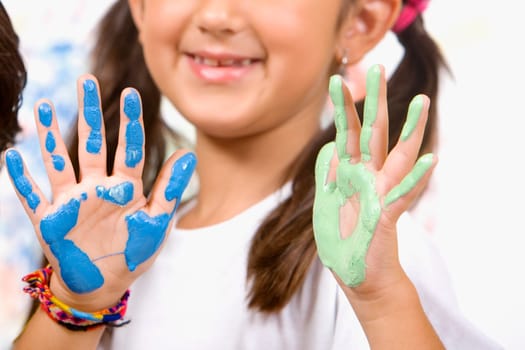 Close-up of a girl showing her painted palms