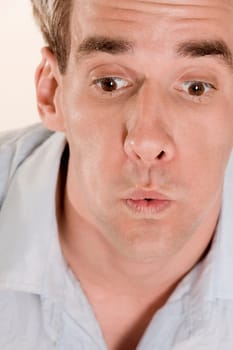 Close-up of a mid adult man looking surprised