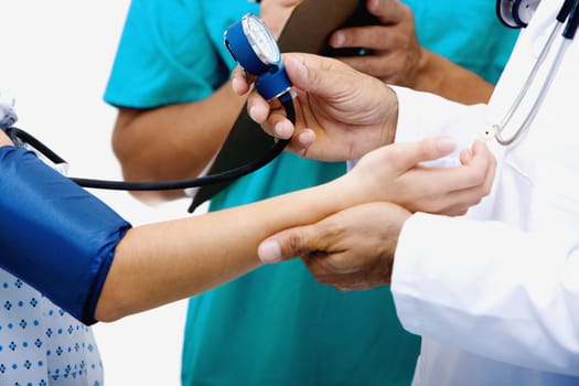 Mid section view of a male doctor measuring blood pressure of a female patient