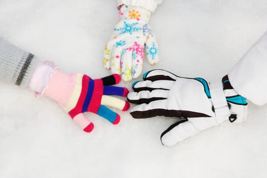Three people playing in snow