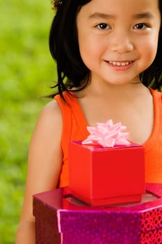 Portrait of a girl holding gifts and smiling