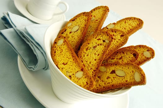 Close-up of slices of almond cake in a bowl