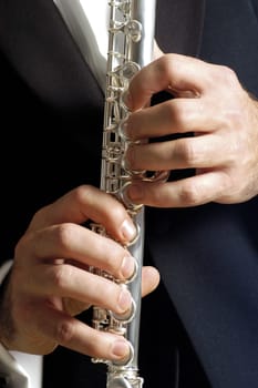 Mid section view of a musician playing the flute