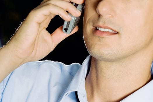 Close-up of a young man using a mobile phone