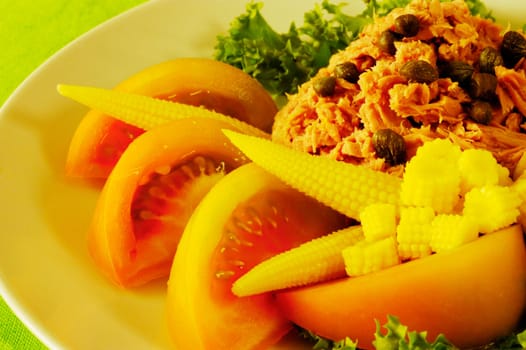 Close-up of tomato slices and baby corn on a plate