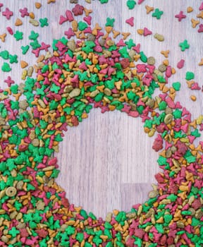 Top view dry cat food on wooden background with copy space