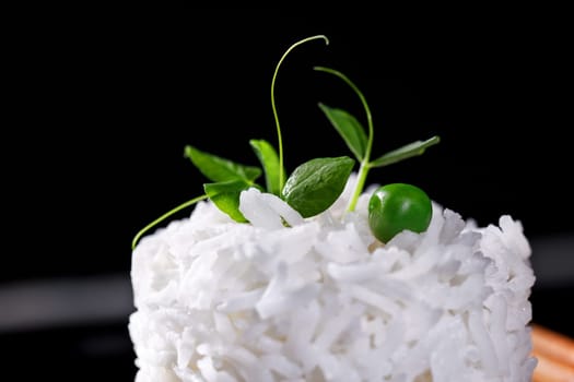 An overhead photo of a bowl of cooked white long grain rice, shot from above on a teal blue background with a place for text