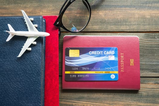 Credit card put on passport on wooden desk , Preparation for Traveling concept