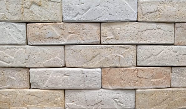 Beige tone stone brick background. Beige brick wall background texture close up