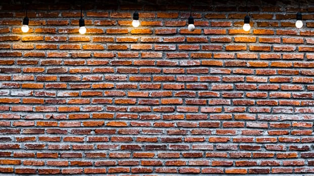 Red brick wall with bulbs vintage and retro background.  Red Brick Empty Wall with Light Bulbs Background. Industrial loft style of decoration.