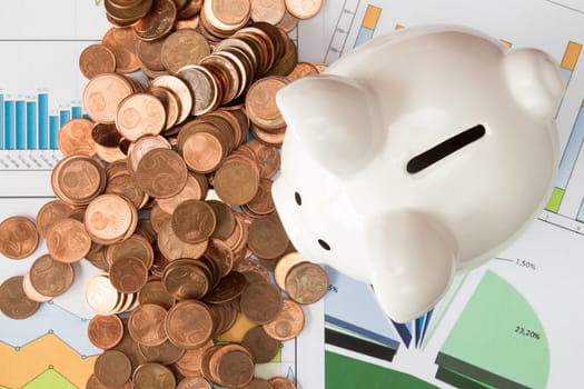 Investment concept or money savings, piggy-bank with Euro cents on paperwork