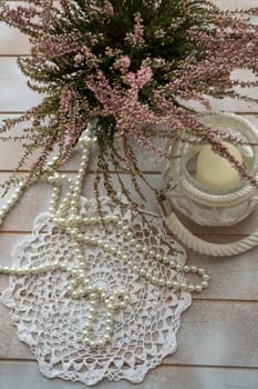 A bouquet of heather on a white shabby table, vertical image