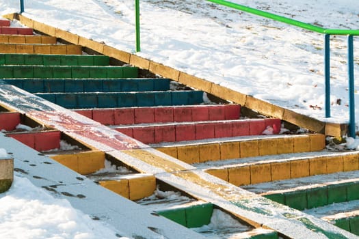 stairs colored in rainbow colors. Diversity multicolored flag concept, snowy day in winter
