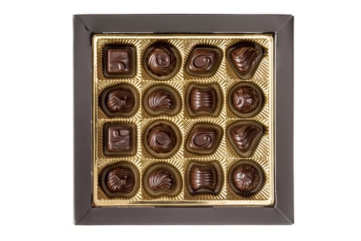 Dark chocolate pralines in a square box isolated on white background