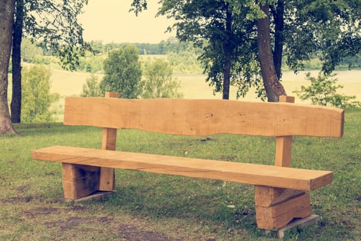 Empty wooden bench in the public park