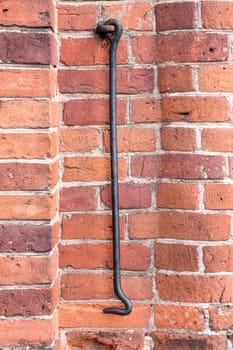 Rusted metal hook attached to wall