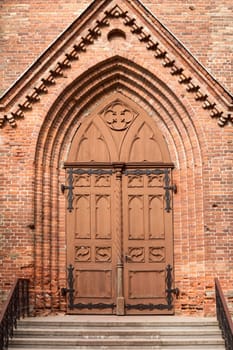 Catholic church front entrance with old wooden doors