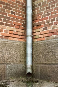 Vintage brick wall texture with drainpipe