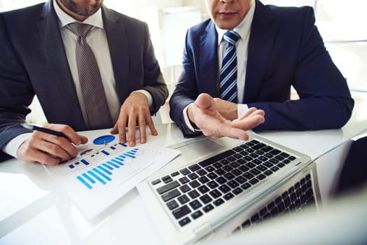 Two men in suits searching for decision in financial issues