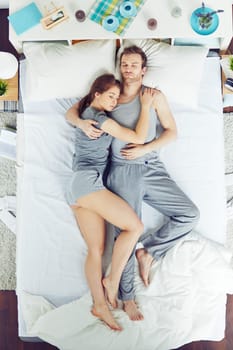 High angle view of couple in bed