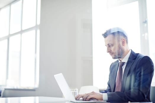 Busy man typing on computer
