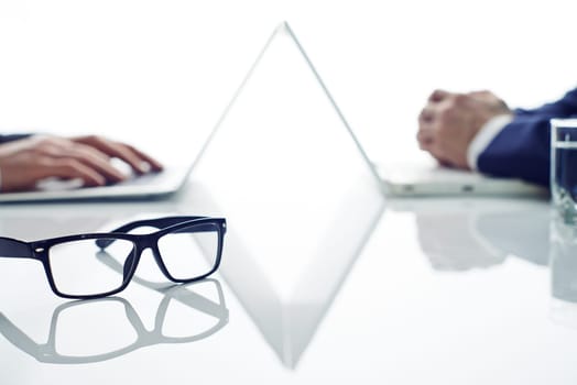 Two businessmen working on table and having different tasks