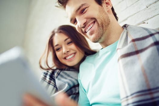 Happy couple using touchpad together
