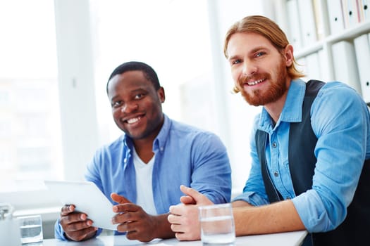 Portrait of two colleagues looking at camera