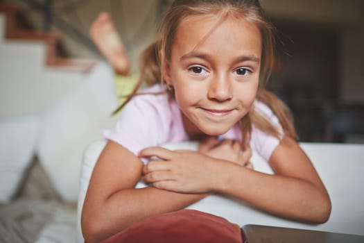Girl lying on couch and raising her legs