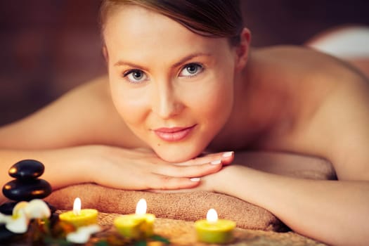 Woman relaxing at beauty spa looking at camera