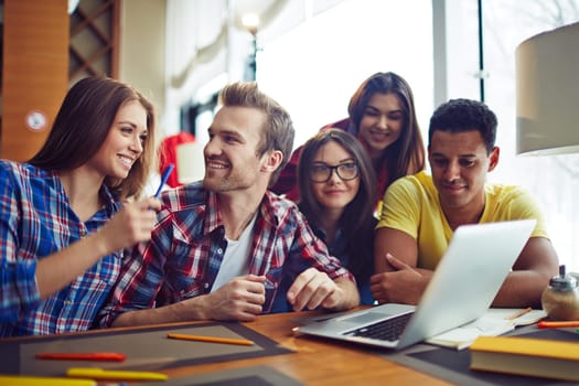 Five students looking at laptop