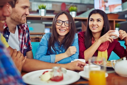 Pretty student having dinner and talking