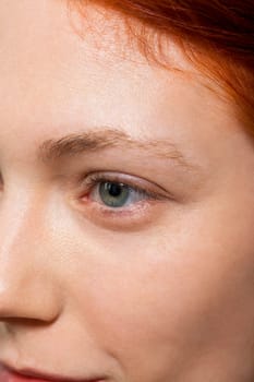 Young pretty woman with red hair wears makeup on nak shot portrait isolated against white background