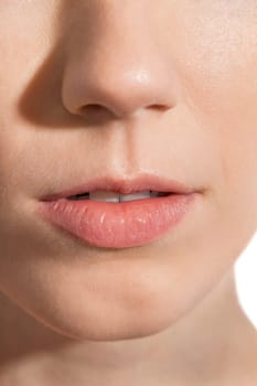 Close-up of a female face with eye lip nose and eyebrows isolated on white background
