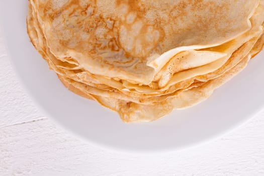 delicious fresh crepes pancakes pancakes on a white plate on a rustic white wooden board