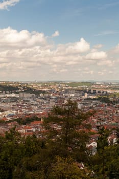 Skyline of Stuttgart with the view over the roofs into the city boiler in Germany with blue sky with small clouds