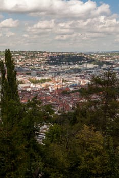 Skyline of Stuttgart with the view over the roofs into the city boiler in Germany with blue sky with small clouds