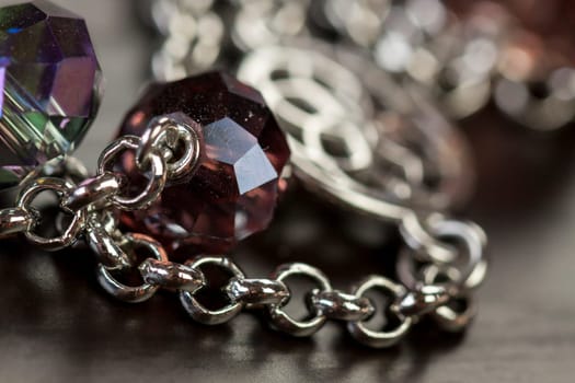 Jewellery fashion jewellery with colored beads as close-up on dark background