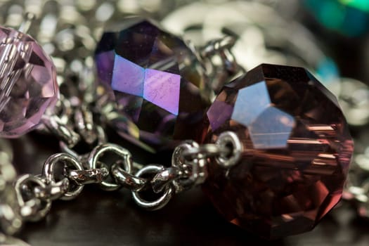 Jewellery fashion jewellery with colored beads as close-up on dark background
